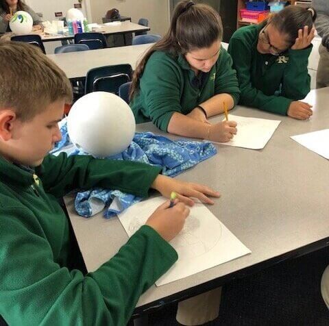 Students drawing in art class