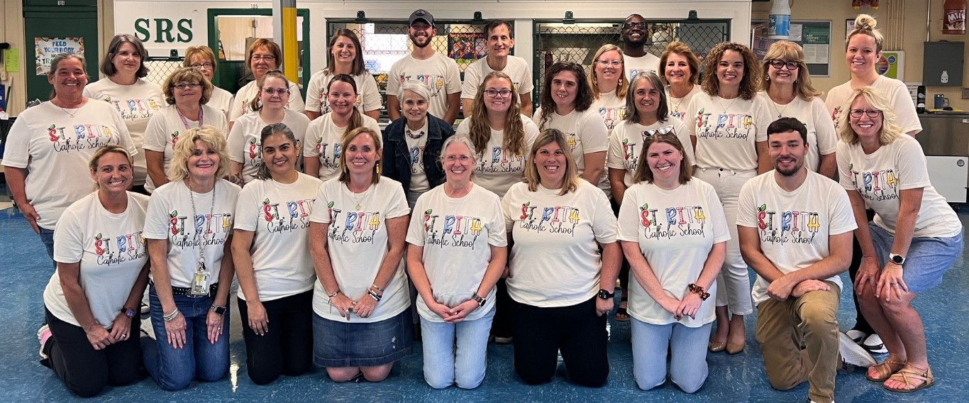 Faculty Photo with all teachers wearing 'Dream Team St. Rita' shirts
