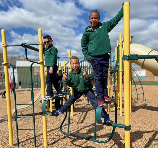 Students standing and posing on playground outside
