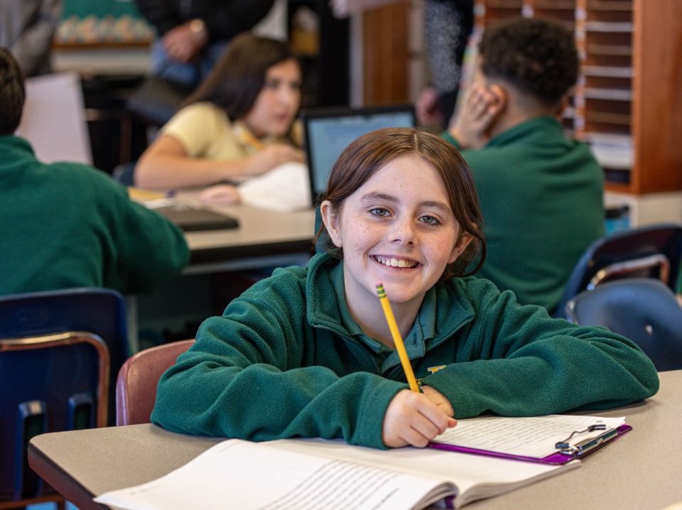 Students at tables working on social studies paper