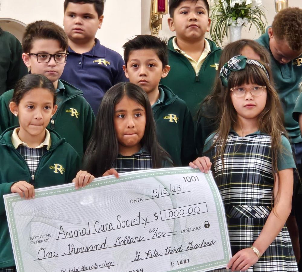 Students holding up $1,000 check for the Animal Care Society